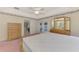 Main bedroom with dresser, access to the back patio, and an ensuite bathroom at 7151 Cork Ln, Englewood, FL 34224