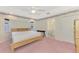 Main bedroom with carpeted floors, an ensuite bathroom, and ceiling fan at 7151 Cork Ln, Englewood, FL 34224