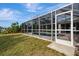 A fully screened pool enclosure and a kidney-shaped pool extends the home's entertaining space to the outdoors at 7151 Cork Ln, Englewood, FL 34224
