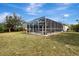 Wide exterior view of the screened in pool that offers relaxation and recreation in the backyard at 7151 Cork Ln, Englewood, FL 34224