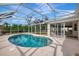 Enjoy the privacy of this kidney-shaped pool and a screened enclosure that connects to the home's interior at 7151 Cork Ln, Englewood, FL 34224