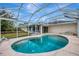 Relax in this kidney-shaped pool within a screened enclosure, offering a private outdoor oasis at 7151 Cork Ln, Englewood, FL 34224