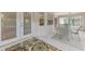 This sunroom features white floors, glass windows, and an interior/exterior access door at 7151 Cork Ln, Englewood, FL 34224