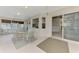 This sunroom features white floors, glass windows, and a ceiling fan at 7151 Cork Ln, Englewood, FL 34224