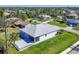 An elevated view captures this home's light purple exterior, screened-in lanai and paver patio in a lush neighborhood at 7499 Ashtabula St, Englewood, FL 34224