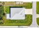 A bird's-eye view showcases this home's new roof, long driveway and lush lawn in a desirable neighborhood at 7499 Ashtabula St, Englewood, FL 34224