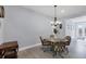 Dining room features a glass table and wicker chairs with backyard view at 7499 Ashtabula St, Englewood, FL 34224