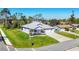 The exterior elevation of this home displays its well-kept lawn, tidy landscaping and light purple exterior at 7499 Ashtabula St, Englewood, FL 34224
