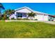 A close exterior view highlights the well-manicured lawn and tidy landscaping of this charming home at 7499 Ashtabula St, Englewood, FL 34224