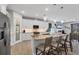 Modern kitchen featuring an island with seating, granite countertops, stainless steel appliances, and white cabinetry at 7499 Ashtabula St, Englewood, FL 34224