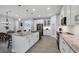 White kitchen featuring a central island, pantry, and stainless steel appliances at 7499 Ashtabula St, Englewood, FL 34224