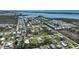 Expansive aerial view of a waterfront community featuring homes with canal access and ocean views at 8164 Archie St, Englewood, FL 34224