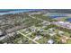 Aerial view of the neighborhood showcasing homes, roads, and nearby waterways and lakes at 8164 Archie St, Englewood, FL 34224