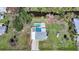 An aerial view of a home featuring a private backyard pool, patio area, and lush green lawn at 8164 Archie St, Englewood, FL 34224