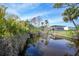 View of canal from backyard, lush greenery at 8164 Archie St, Englewood, FL 34224