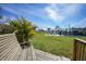 Inviting backyard with a wooden deck, lush lawn, and a glimpse of the home's exterior at 8164 Archie St, Englewood, FL 34224