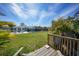 Backyard view of house, pool and patio from wooden deck at 8164 Archie St, Englewood, FL 34224