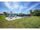 A backyard featuring a patio with seating and a fenced swimming pool for outdoor relaxation at 8164 Archie St, Englewood, FL 34224