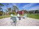 Backyard patio with stone pavers, four chairs and fire pit at 8164 Archie St, Englewood, FL 34224