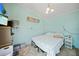 Bedroom with light blue walls, decorated with beachy art, and a cozy bed, awaits personalization at 8164 Archie St, Englewood, FL 34224