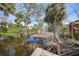 Canal view with overhanging palms from backyard at 8164 Archie St, Englewood, FL 34224