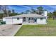 Charming single-story home with a welcoming front porch, an attached garage, and a well-maintained lawn at 8164 Archie St, Englewood, FL 34224