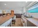 The spacious kitchen features butcher block countertops, natural light, and open shelving at 8164 Archie St, Englewood, FL 34224