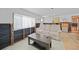 Inviting living room with a neutral-toned sofa, dark wood coffee table, and natural light from the window at 8164 Archie St, Englewood, FL 34224