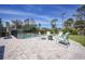 Backyard features inviting fenced pool, with comfortable seating and a fire pit for entertaining at 8164 Archie St, Englewood, FL 34224