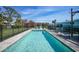 Backyard pool with surrounding brick pavers, safety fence, and lawn at 8164 Archie St, Englewood, FL 34224
