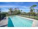 Fenced in swimming pool, with a view of the lush landscaping, offers a secure backyard oasis at 8164 Archie St, Englewood, FL 34224
