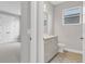 Hall bathroom showcases stylish vanity, tile floors and natural lighting at 8375 E Windbound Ct Ct, Sarasota, FL 34240