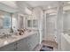 Modern bathroom featuring double vanity with granite countertop and large walk-in closet at 8375 E Windbound Ct Ct, Sarasota, FL 34240