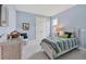 Comfortable bedroom with bright natural light and wicker furniture at 8375 E Windbound Ct Ct, Sarasota, FL 34240