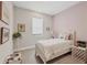 Serene bedroom with pink accent wall and cozy white wicker bed at 8375 E Windbound Ct Ct, Sarasota, FL 34240