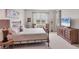 Cozy bedroom with metal bed frame, patterned bedding, and a wooden dresser at 8375 E Windbound Ct Ct, Sarasota, FL 34240