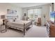 Bright bedroom with a large window, decorative lamps, and a decorative metal-framed bed at 8375 E Windbound Ct Ct, Sarasota, FL 34240