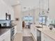 Open floor plan featuring a modern kitchen with sleek appliances and spacious dining area at 8375 E Windbound Ct Ct, Sarasota, FL 34240