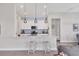 Stylish kitchen with white cabinets, stainless steel appliances, and a quartz countertop island with seating at 8375 E Windbound Ct Ct, Sarasota, FL 34240