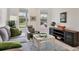 Well-lit living room features a comfortable grey couch, armchair, and stylish furniture at 8375 E Windbound Ct Ct, Sarasota, FL 34240