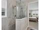Walk-in shower featuring rainfall shower head and seamless glass partition at 8375 E Windbound Ct Ct, Sarasota, FL 34240