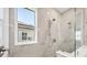 Modern shower with large window, marble tile and rainfall showerhead at 8375 E Windbound Ct Ct, Sarasota, FL 34240