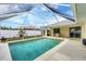 Inviting screened-in pool with clear blue water, surrounded by patio and lush landscaping at 9089 Bantry Bay Blvd, Englewood, FL 34224