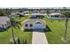 The home is situated on a lush lot with mature palm trees and landscaping at 9423 El Campo Ave, Englewood, FL 34224
