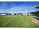 A view of the green lawn and a glimpse of the home’s back porch and shed showcases this home’s outdoor space at 9423 El Campo Ave, Englewood, FL 34224