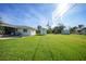 The expansive backyard includes a storage shed and is surrounded by lush green grass at 9423 El Campo Ave, Englewood, FL 34224