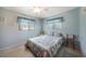 This beautiful bedroom is brightly lit, with a neutral carpet and ceiling fan at 9423 El Campo Ave, Englewood, FL 34224