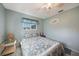 This pretty bedroom is painted blue with bright white trim and a ceiling fan at 9423 El Campo Ave, Englewood, FL 34224