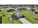 Well-maintained home featuring a lush lawn and mature palm trees, adding to its curb appeal at 9423 El Campo Ave, Englewood, FL 34224