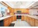 Traditional kitchen featuring wood cabinets, white countertops, and appliances at 9423 El Campo Ave, Englewood, FL 34224